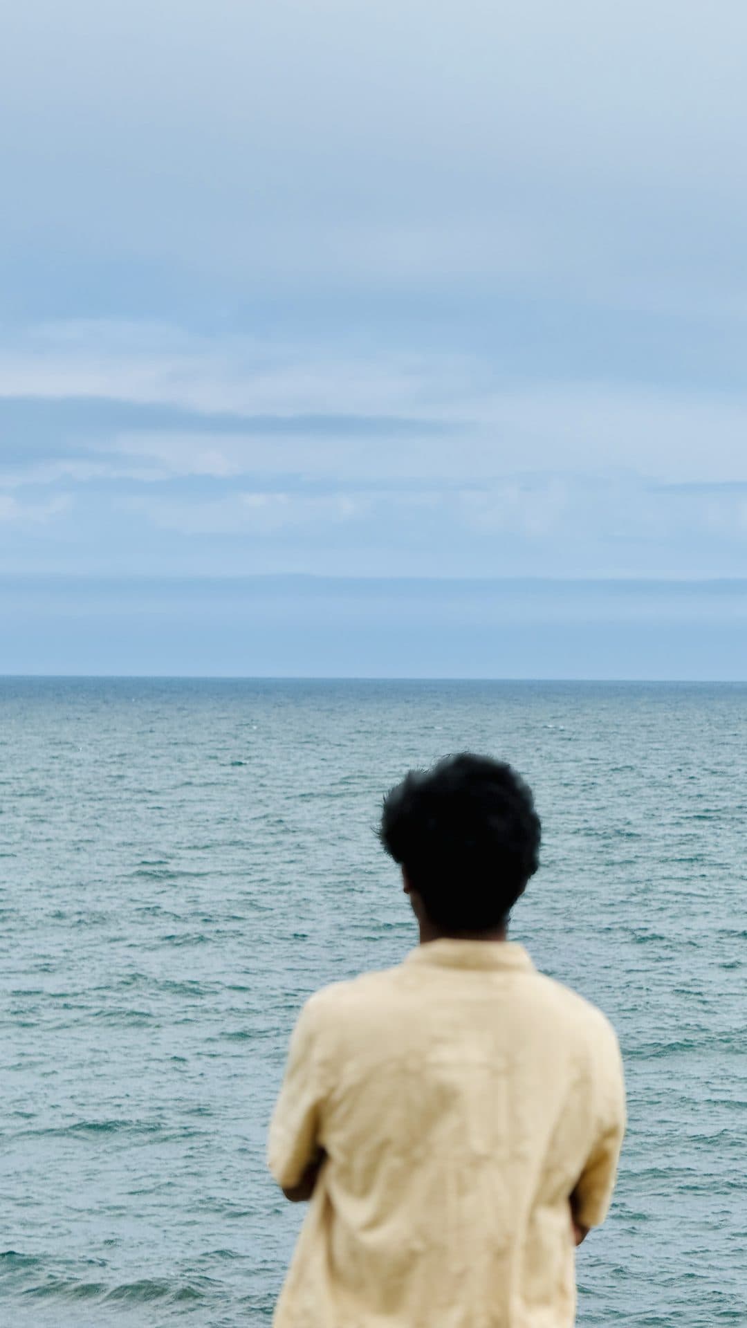 A person looking out across the sea