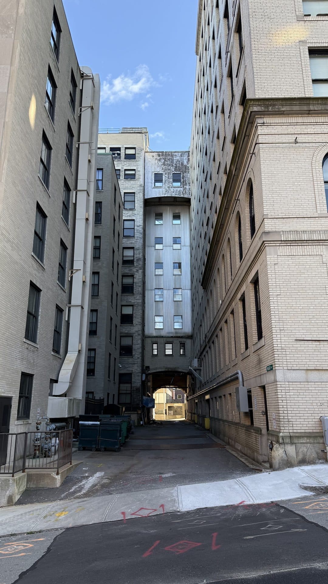 A narrow passage between tall city buildings