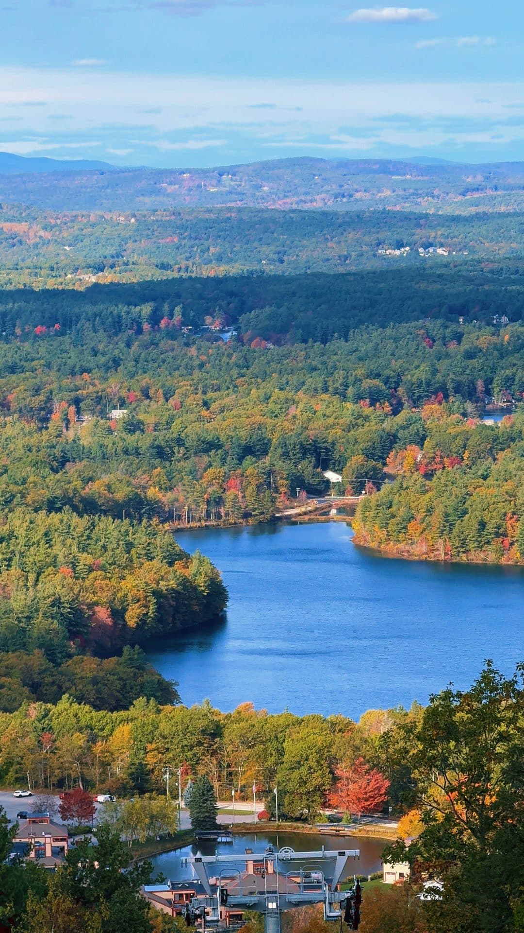 A lake surrounded by wooded hills, seen from above