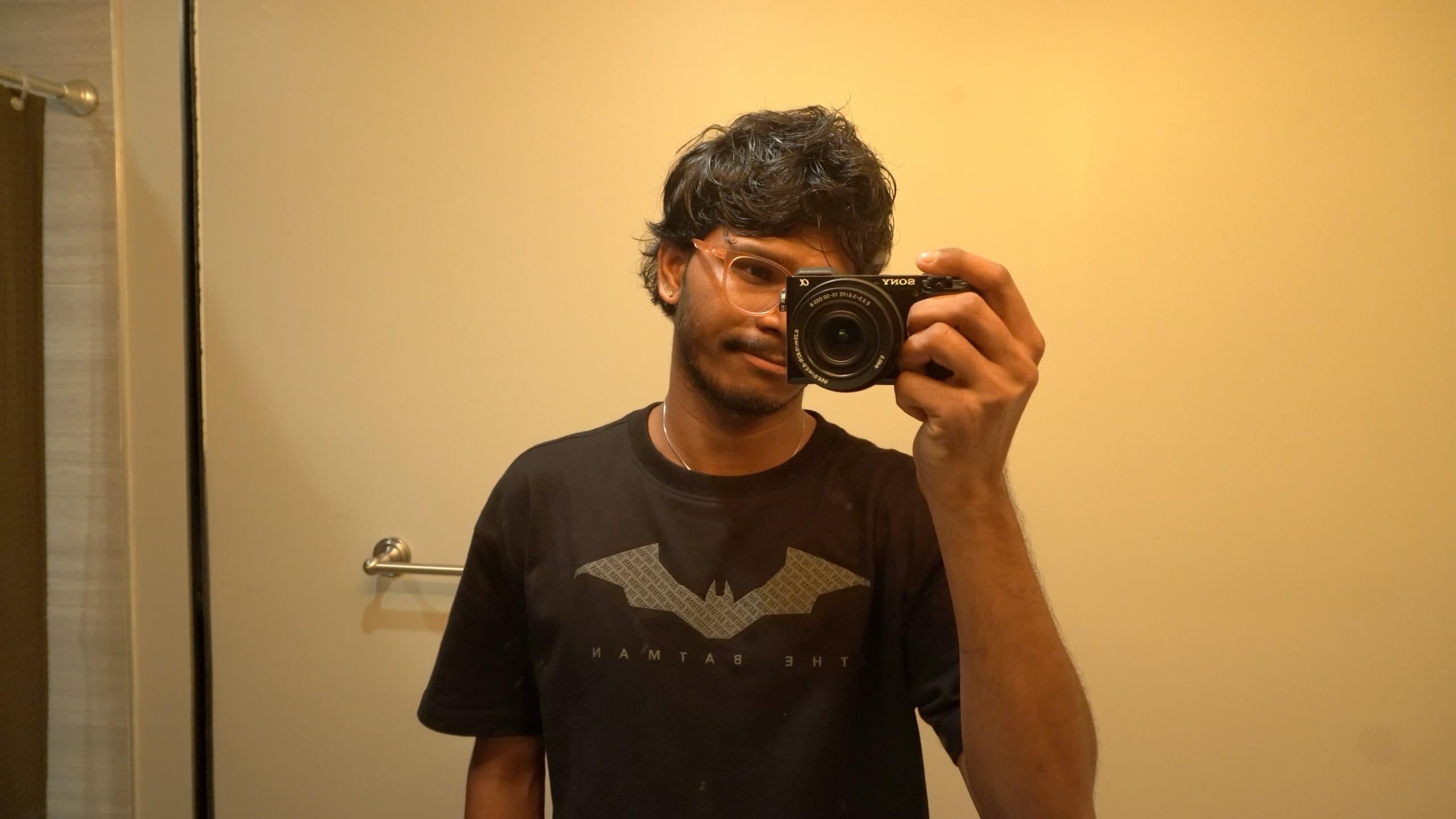 Ajay taking a mirror photograph with his camera in warm light